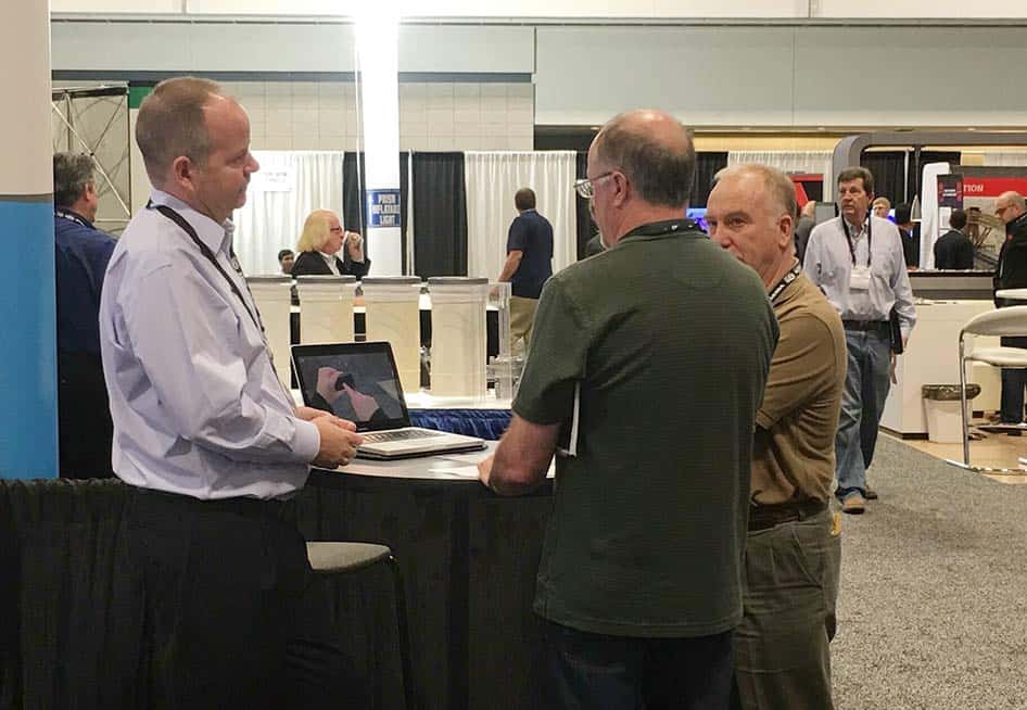CEO David Boardman discusses inventory challenges with booth visitors at 2016 AGG1 conference.